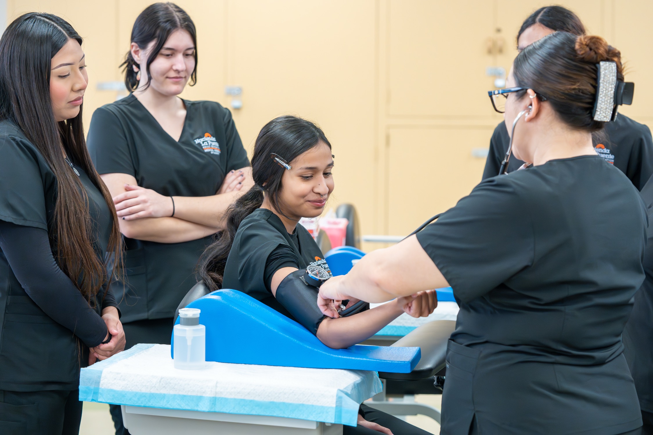 students practicing taking blood pressure